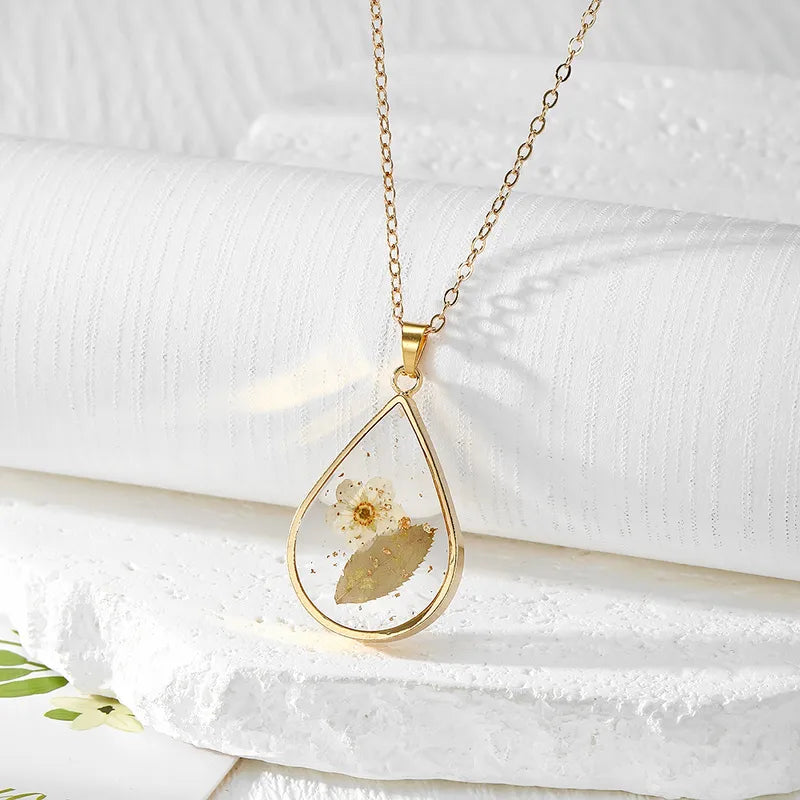 Resin Pendant - A White Flower with Green Leaves
