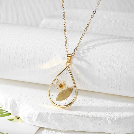 Resin Pendant - A White Flower with Green Leaves